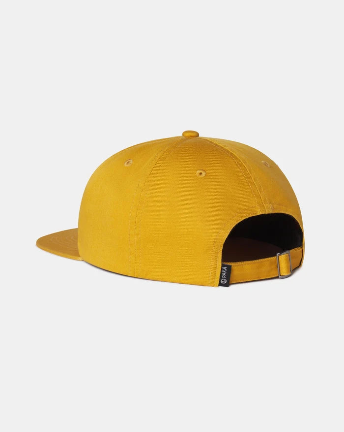 Rear view of Adventure Hat showing adjustable strap, flat brim, and PAKA tag in harvest gold on light gray background