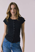 Front view of a woman wearing the Chaser Anchor Black Tee with buttons and blue jeans against a plain background