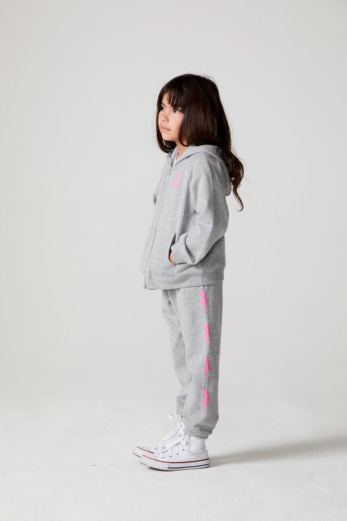 Full body side view of a girl wearing the Chaser  Bolting Bolt Long Sleeve on a neutral background