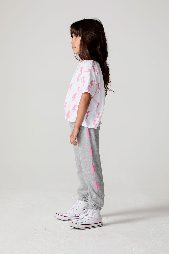 Full body side view of a girl wearing the Chaser  Bolting Bolt Pant on a neutral background