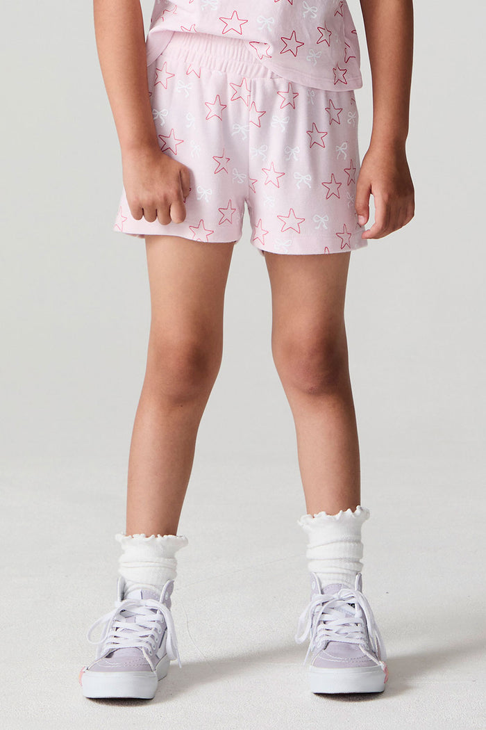 Front view of a girl wearing the Chaser Bows and Stars Shorts and matching top on a neutral background