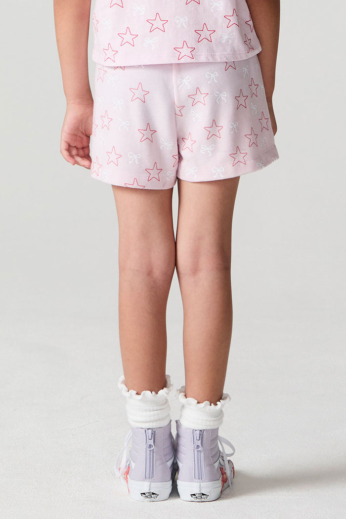 Back view of a girl wearing the Chaser Bows and Stars Shorts on a neutral background