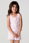 Front view of a girl wearing the Chaser Check Bow Tank and matching star shorts on a neutral background with arms crossed