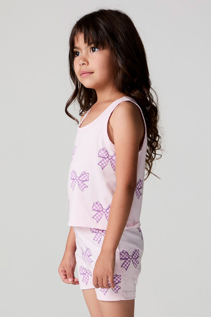 Side view of a girl wearing the Chaser Check Bow Tank and shorts on a neutral background