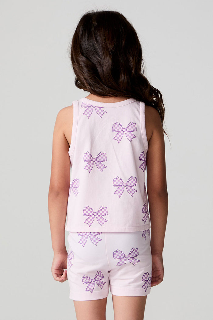 Back view of a girl wearing the Chaser Check Bow Tank and shorts on a neutral background