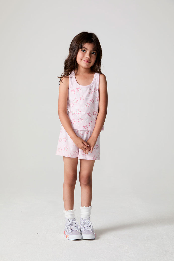 Front view of a girl wearing the Chaser Check Bow Tank and matching shorts on a neutral background with arms crossed