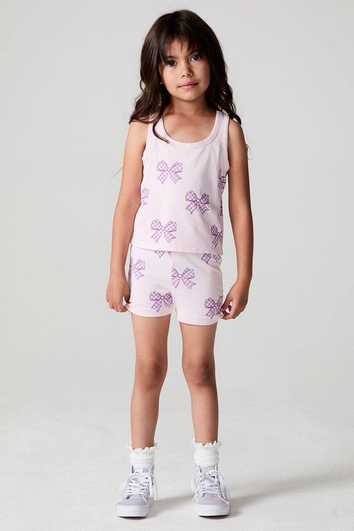 A full body front view of a girl wearing the Chaser Check Bow Tank and shorts on a neutral background