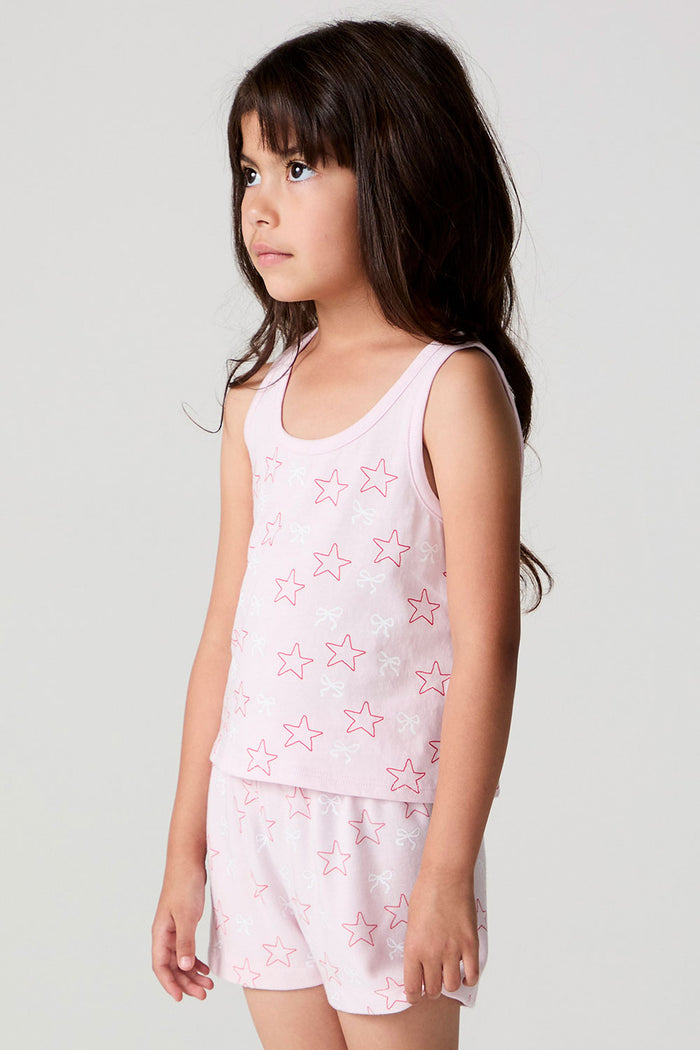 Side angle view of a girl wearing the Chaser Check Bow Tank on a neutral background with arms down