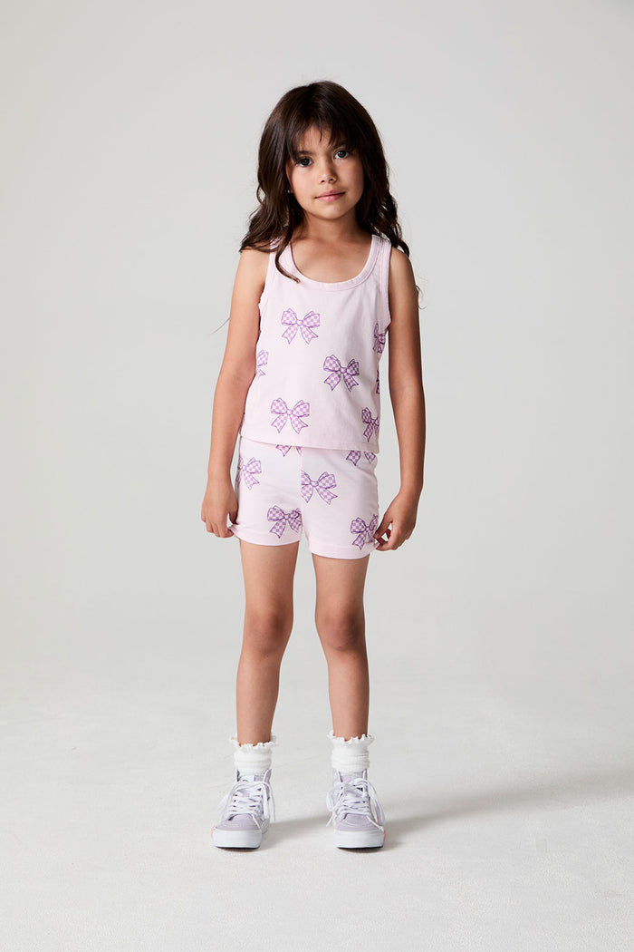 A full body front view of a girl wearing the Chaser Check Bow Tank on a neutral background