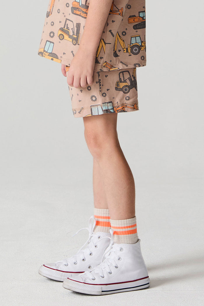Side view of a boy wearing the Chaser Construction Days Shorts on a neutral background