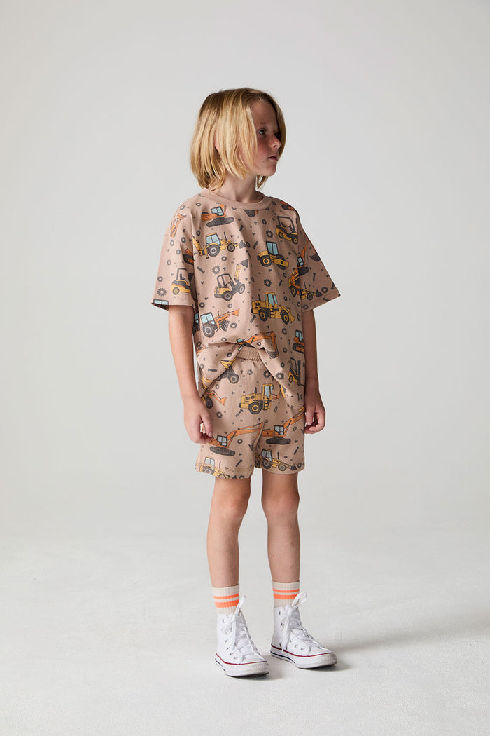 Full body side view of a boy wearing the Chaser Construction Days Shorts on a neutral background