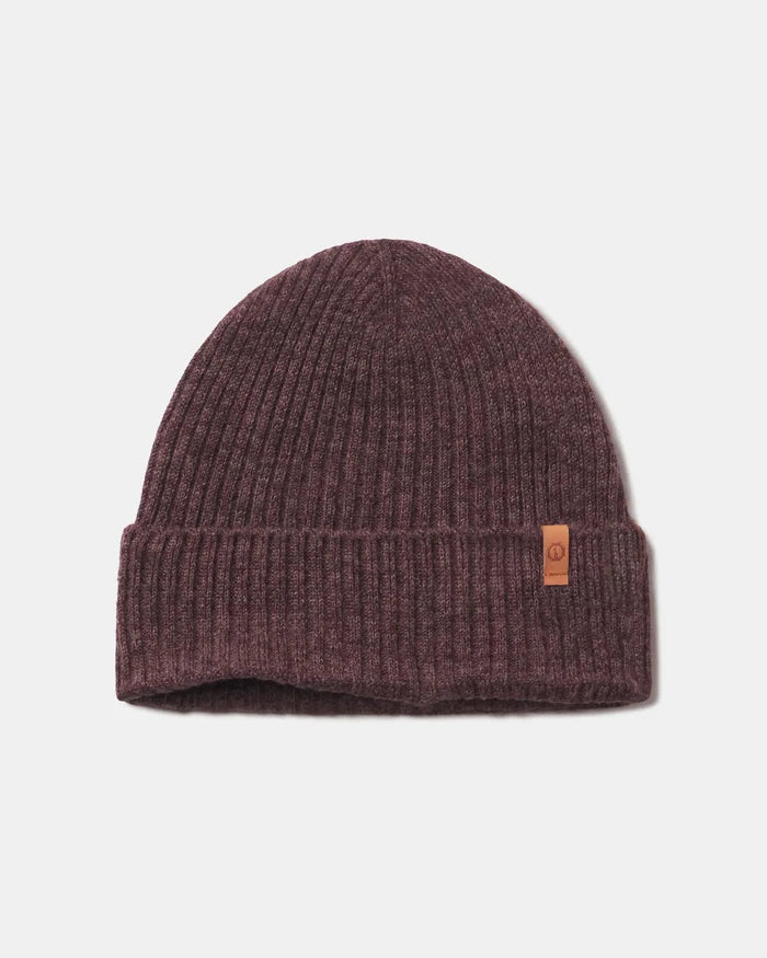 Front view of Cozy Marled Beanie showcasing ribbed knit and folded cuff with small leather logo tag on light gray background