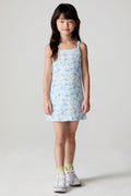 Front view of a girl wearing the Chaser Ditsy Daisies Dress on a neutral background