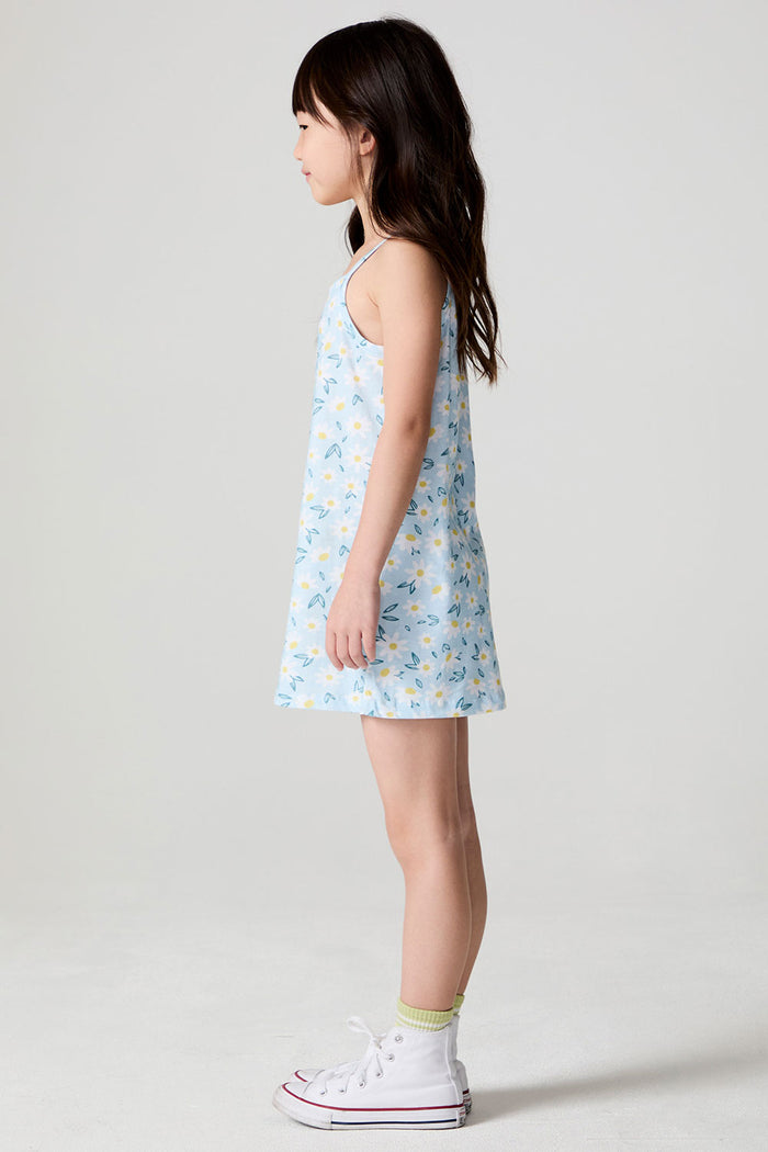 Side view of a girl wearing the Chaser Ditsy Daisies Dress on a neutral background