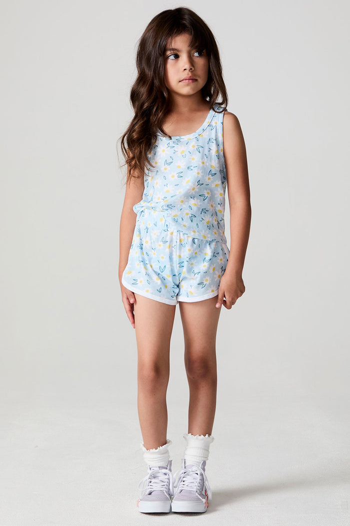 A full body front view of a girl wearing the Chaser Ditsy Daisies Shorts on a neutral background