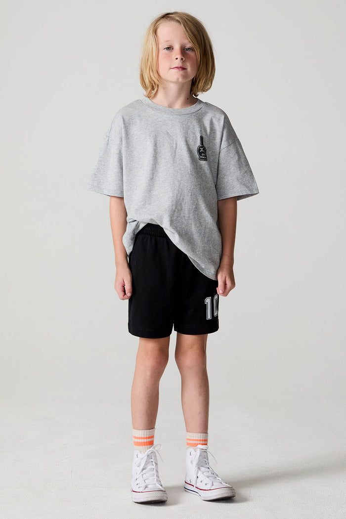 A full body front view of a boy wearing the Chaser Go Team Shorts on a neutral background