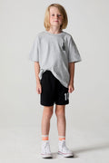 A full body front view of a boy wearing the Chaser Go Team Shorts on a neutral background