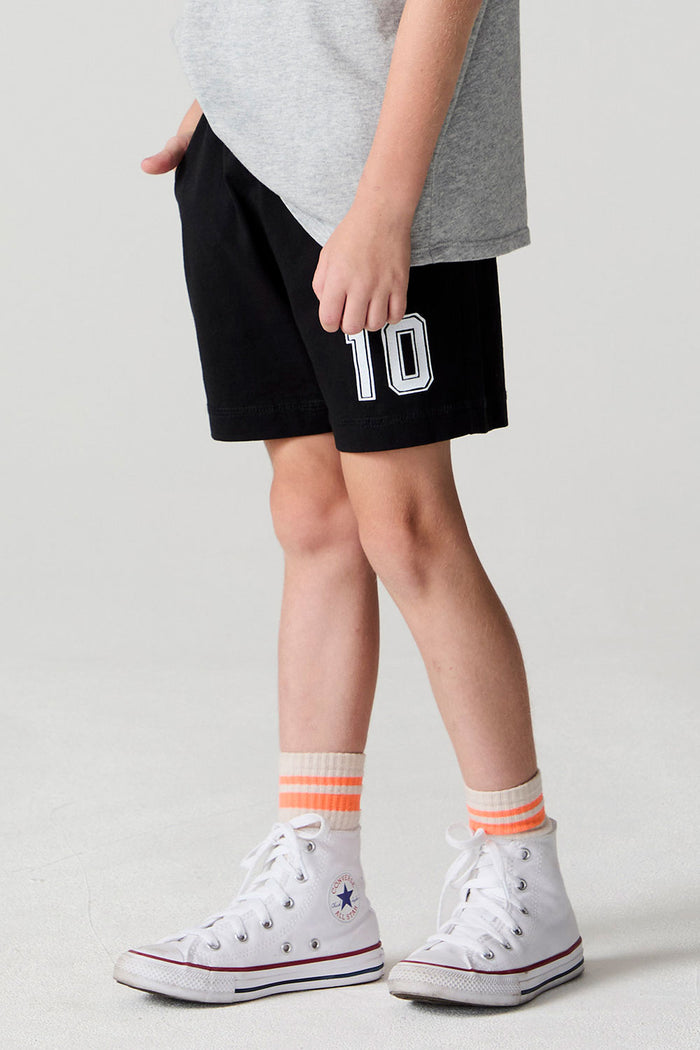 Side angle view of a boy wearing the Chaser Go Team Shorts on a neutral background