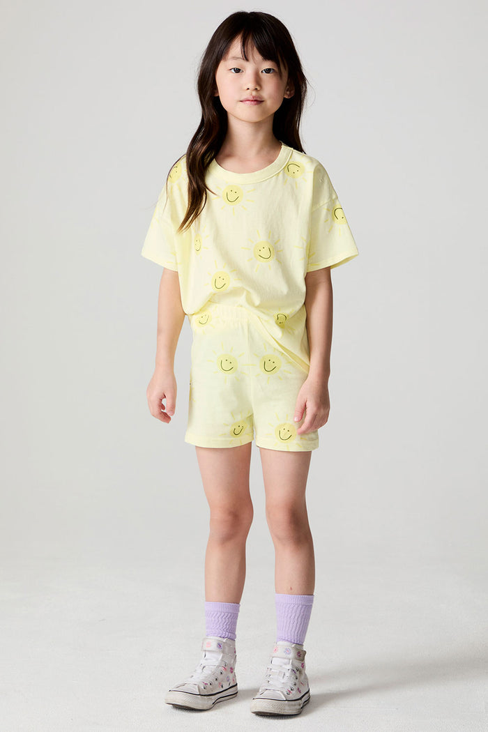 Front view of a girl wearing the Chaser Happy Happy Shorts and matching Happy Happy shorts on a neutral background with arms at her side