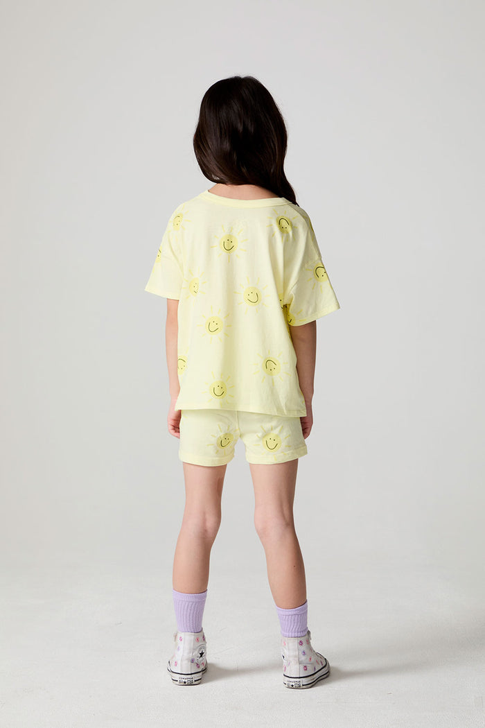Back view of a girl wearing the Chaser Happy Happy Shorts and matching shorts on a neutral background