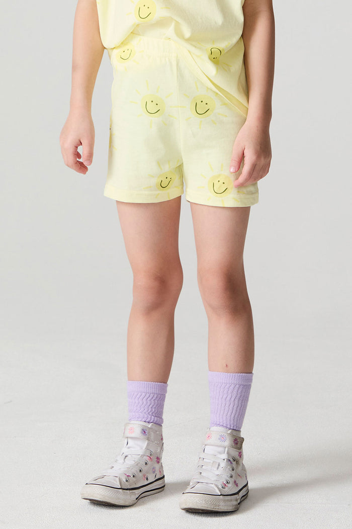 Front view of a girl wearing the Chaser Happy Happy Shorts and white sneakers on a neutral background