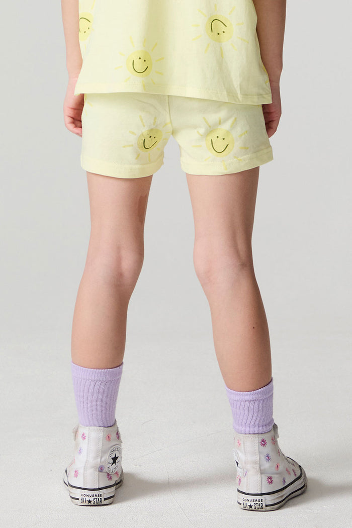 Back view of a girl wearing the Chaser Happy Happy Shorts on a neutral background
