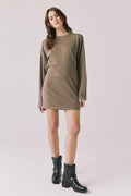 Full body view of woman wearing Chaser’s Ginger Brown Margarita Mini Dress with black boots on a plain background