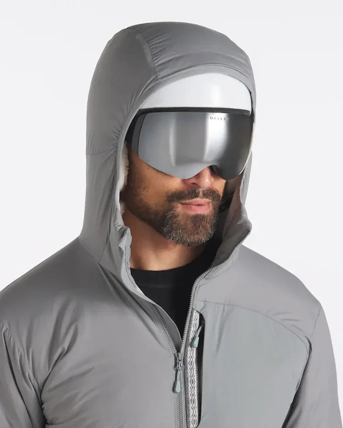 Front close-up of Men’s Apu Lightweight Puffer in Storm gray on model showing hood, full zip and chest pocket