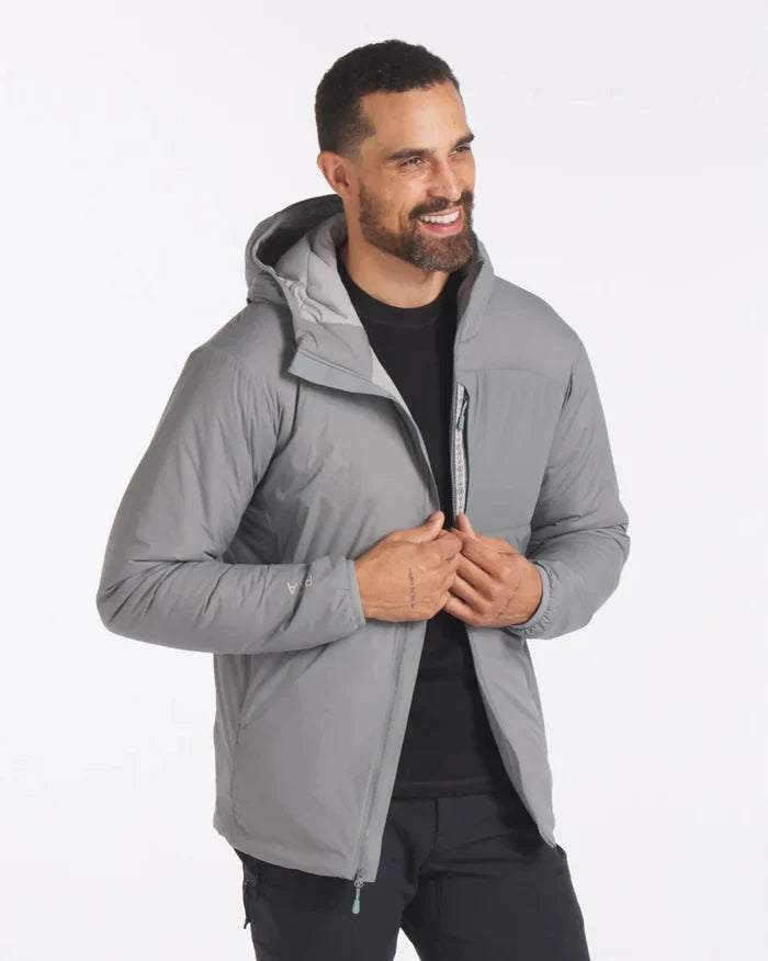Three-quarter view of Men’s Apu Lightweight Puffer jacket in Storm gray with hood and chest zip pocket on model