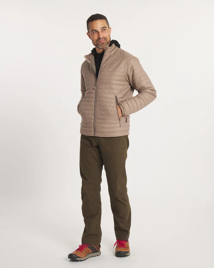 Three-quarter front of Men’s Mayu Ultralight Jacket in fossil with quilted packable puffer, zip pockets and collar on model
