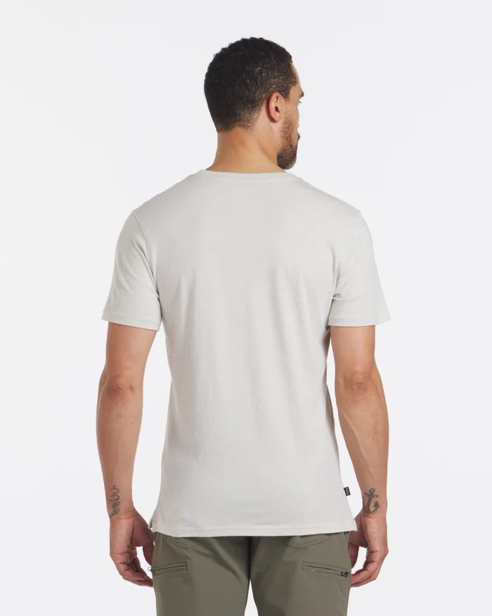 Back view of Men’s Pocket Tee in bone showing regular fit, short sleeves, crew neck, and straight hem on model against white background