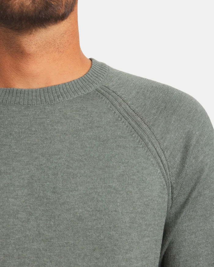 Close-up of Men’s Ultralight Crew in lichen showcasing ribbed crewneck and raglan shoulder seam with light gray background