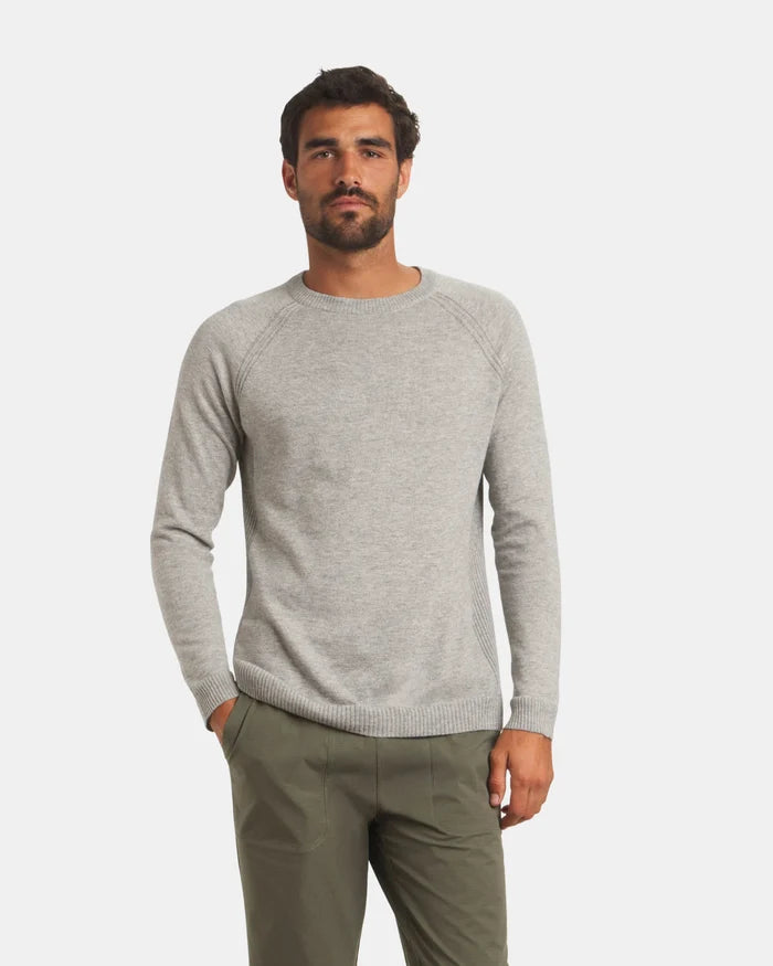 Front view of Men’s Ultralight Crew sweater in ice heather grey on model, lightweight knit with raglan sleeves and ribbed cuffs and hem