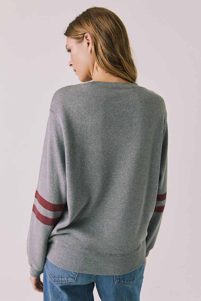 Back view of woman wearing Chaser’s Streaky Grey Merry Long Sleeve against a plain background