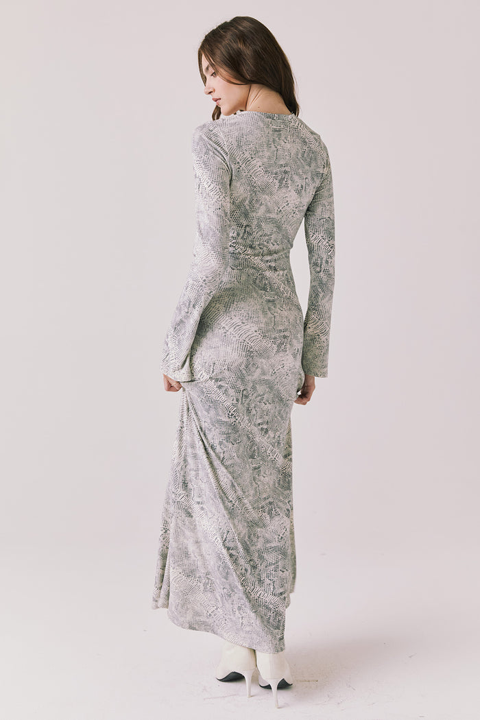 Full body back view of woman wearing Chaser’s light Opal Python Print Maxi Dress with long sleeves and relaxed fit against a white background