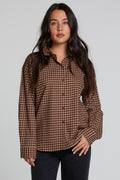 Front view of a woman wearing the Chaser Pine button down on a neutral background