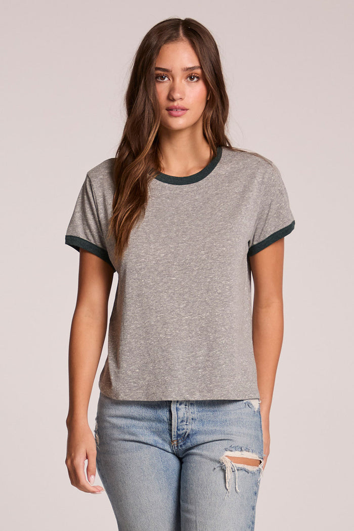 Front view of a woman wearing the Chaser  Rambler Streaky Grey and Pine Tee and jeans on a neutral background
