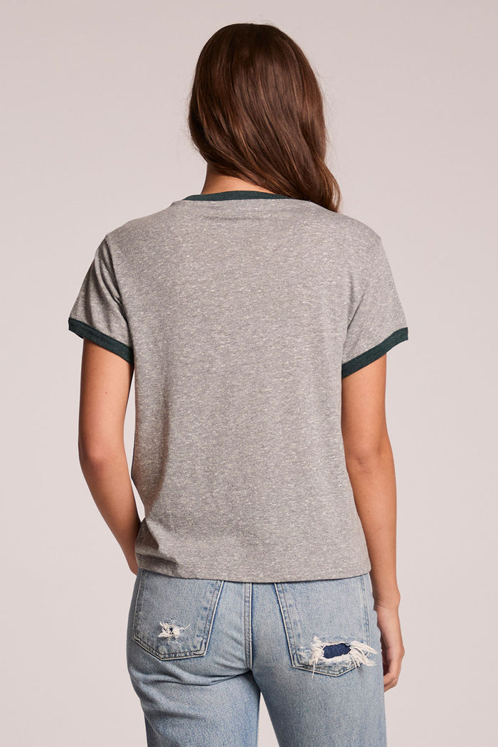 Back view of a woman wearing the Chaser  Rambler Streaky Grey and Pine Tee on a neutral background