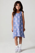 A full body front view of a girl wearing the Chaser Seashell Dreams Allover Dress on a neutral background with arms down
