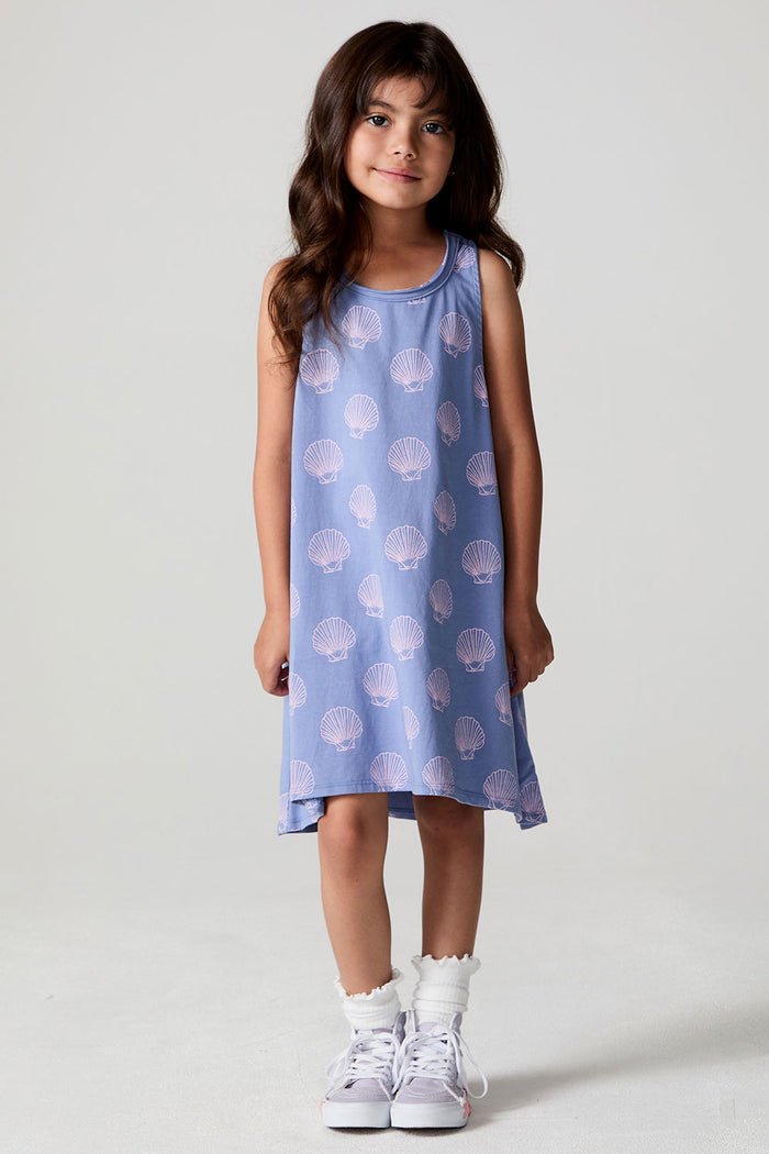 A full body front view of a girl wearing the Chaser Seashell Dreams Allover Dress on a neutral background with arms down