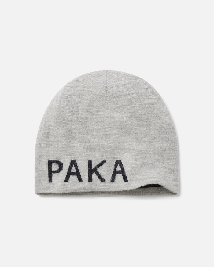 Top view of Skull Cap Beanie showcasing light grey knit and PAKA logo on cuff against white background