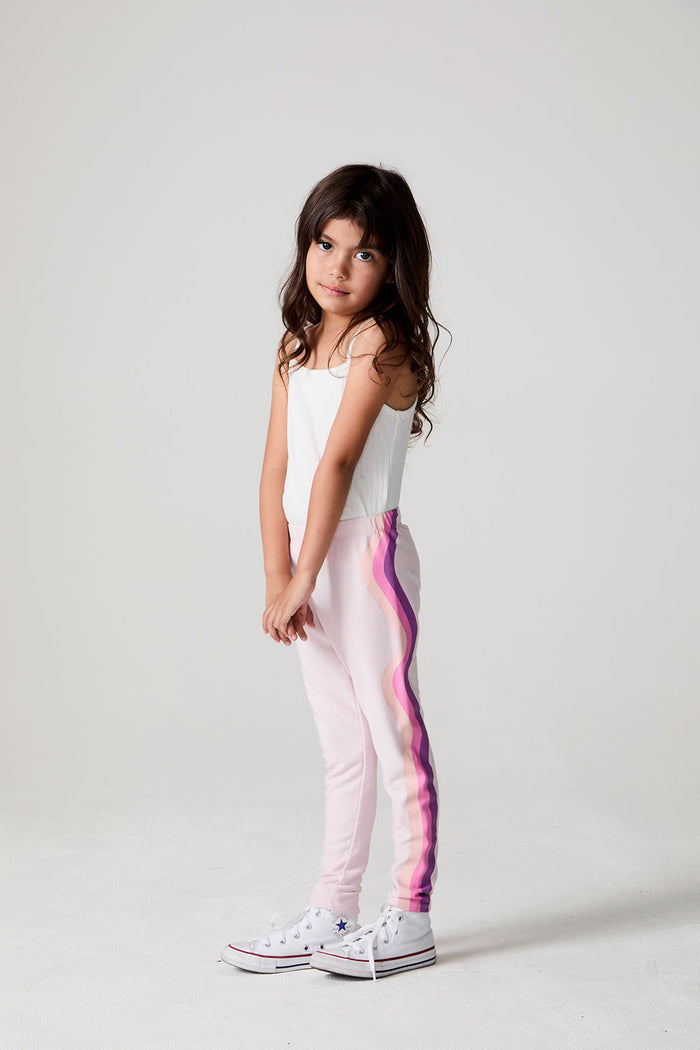 Full body side view of a girl wearing the Chaser Slim Begonia Leggings on a neutral background