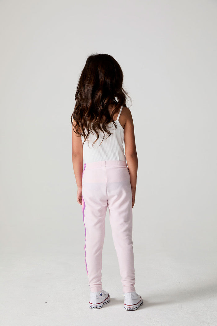 Full body back view of a girl wearing the Chaser Slim Begonia Leggings on a neutral background