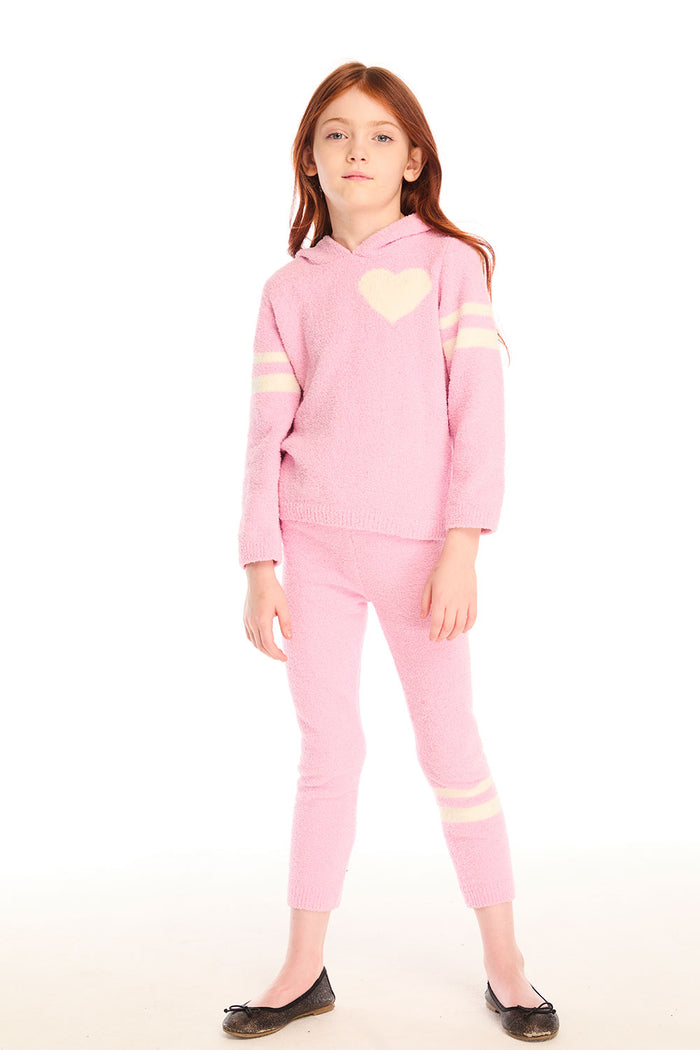 Full body view of girl wearing Chaser’s pink Slim Confetti Legging with matching Cropped Shirred Confetti Hoodie with a heart design on a white background