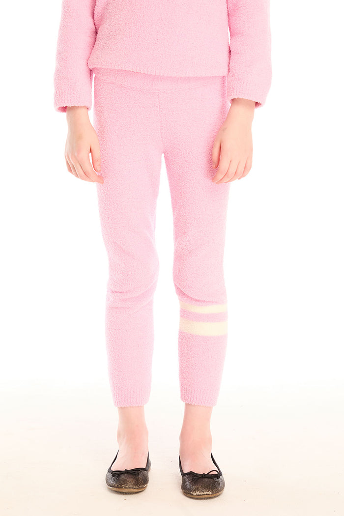 Girl wearing Chaser’s pink Slim Confetti Legging on a white background