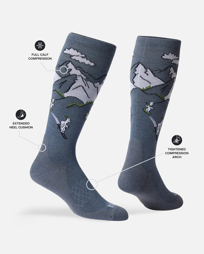 Two angled Snow Sebastian ski socks with mountain pattern, full-calf compression, extended heel cushion, tightened arch