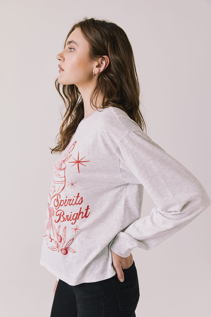 Side view of woman wearing Chaser’s Spirits Bright Light Grey Long Sleeve on a light gray background