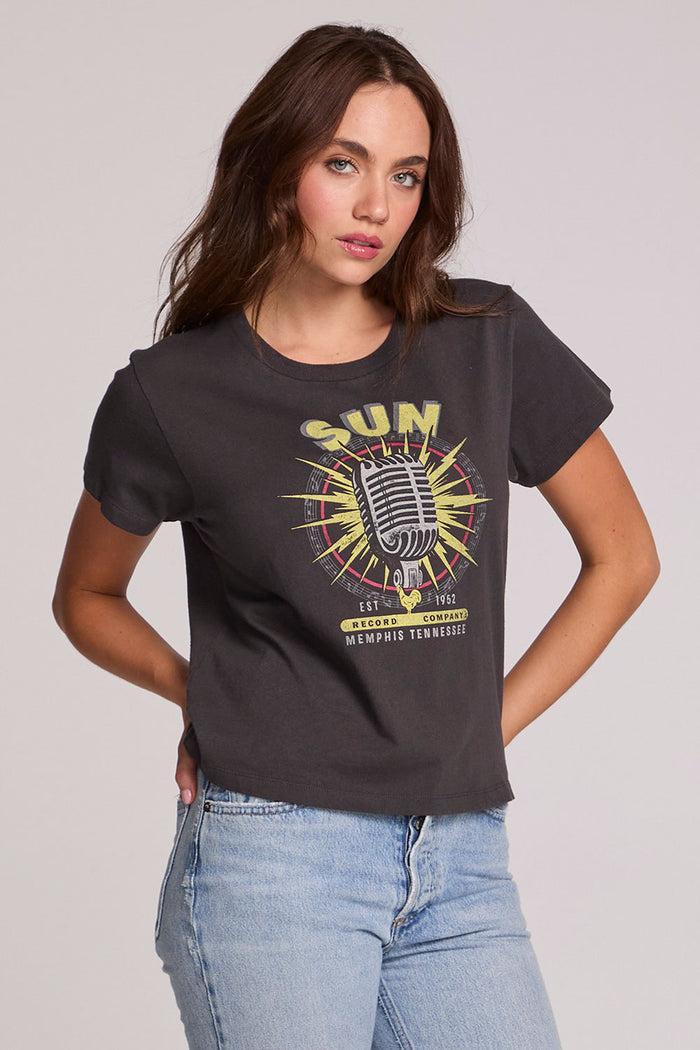 A full body front view of a woman wearing the Chaser Sun Records Tee on a neutral background