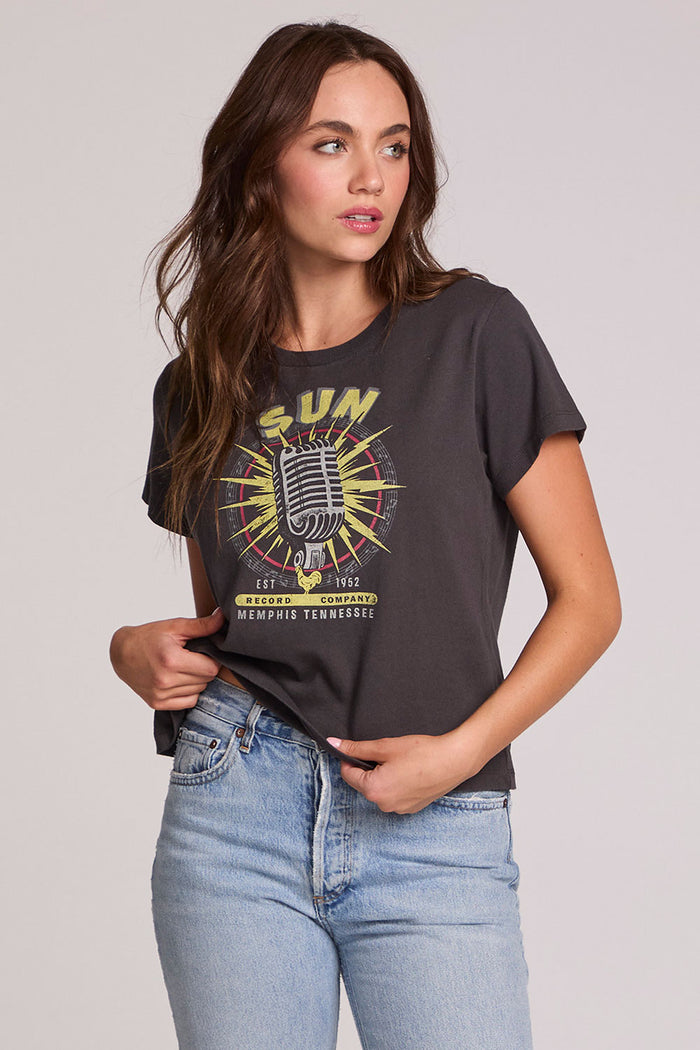 A front view of a woman wearing the Chaser Sun Records Tee on a neutral background with arms on her hip