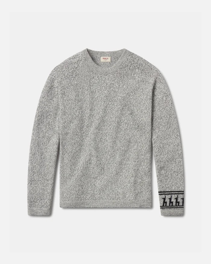 Front flat lay of The Costa alpaca sweater showcasing textured knit and patterned cuff in light grey on a light background